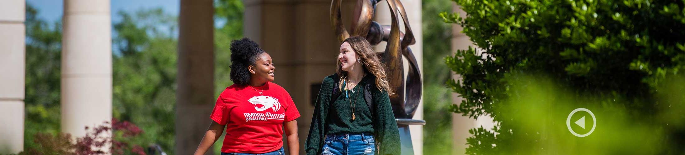 Students walking on USA campus outside of Moulton Tower.